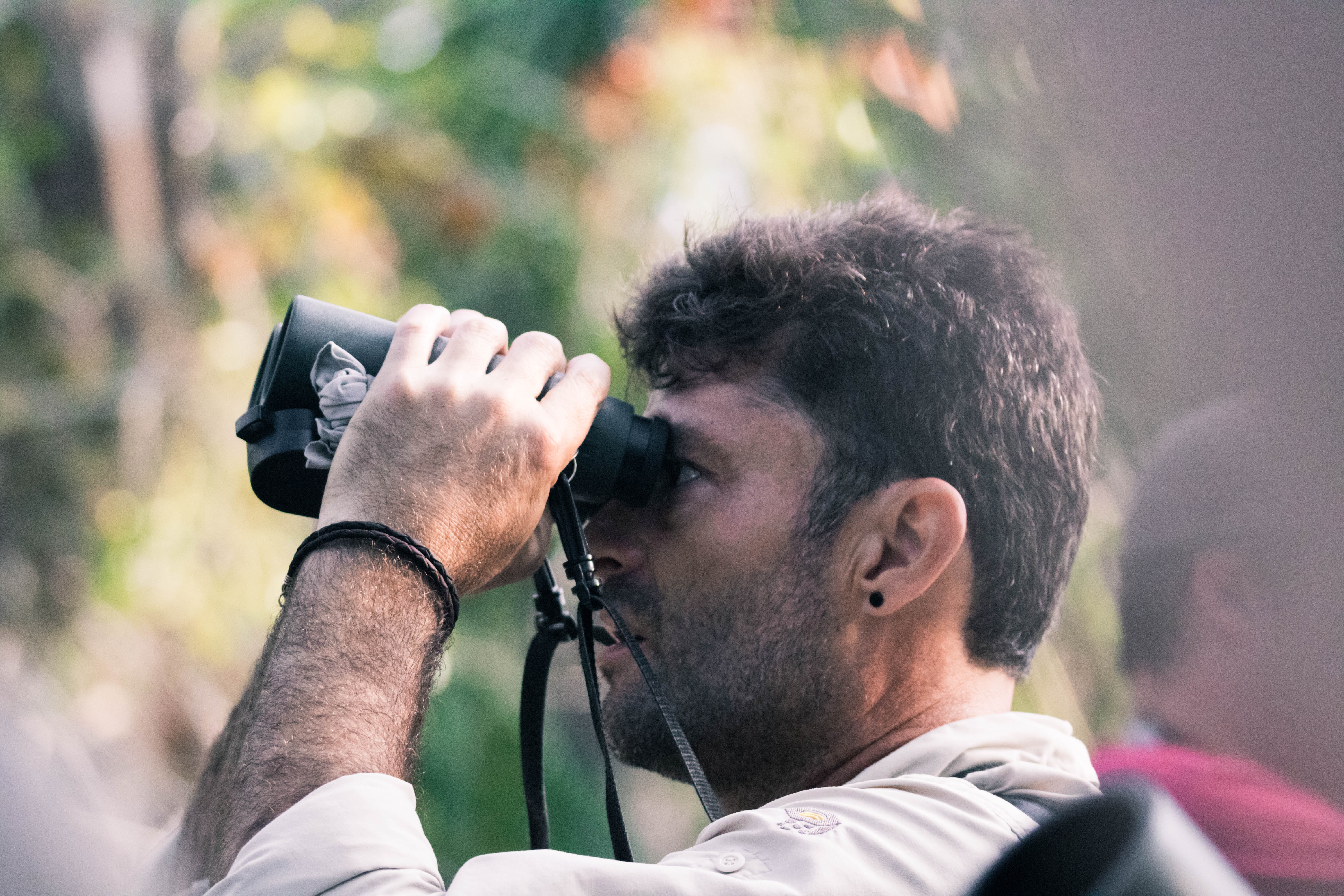 man birding with binoculars in ponta malongane, mozambique