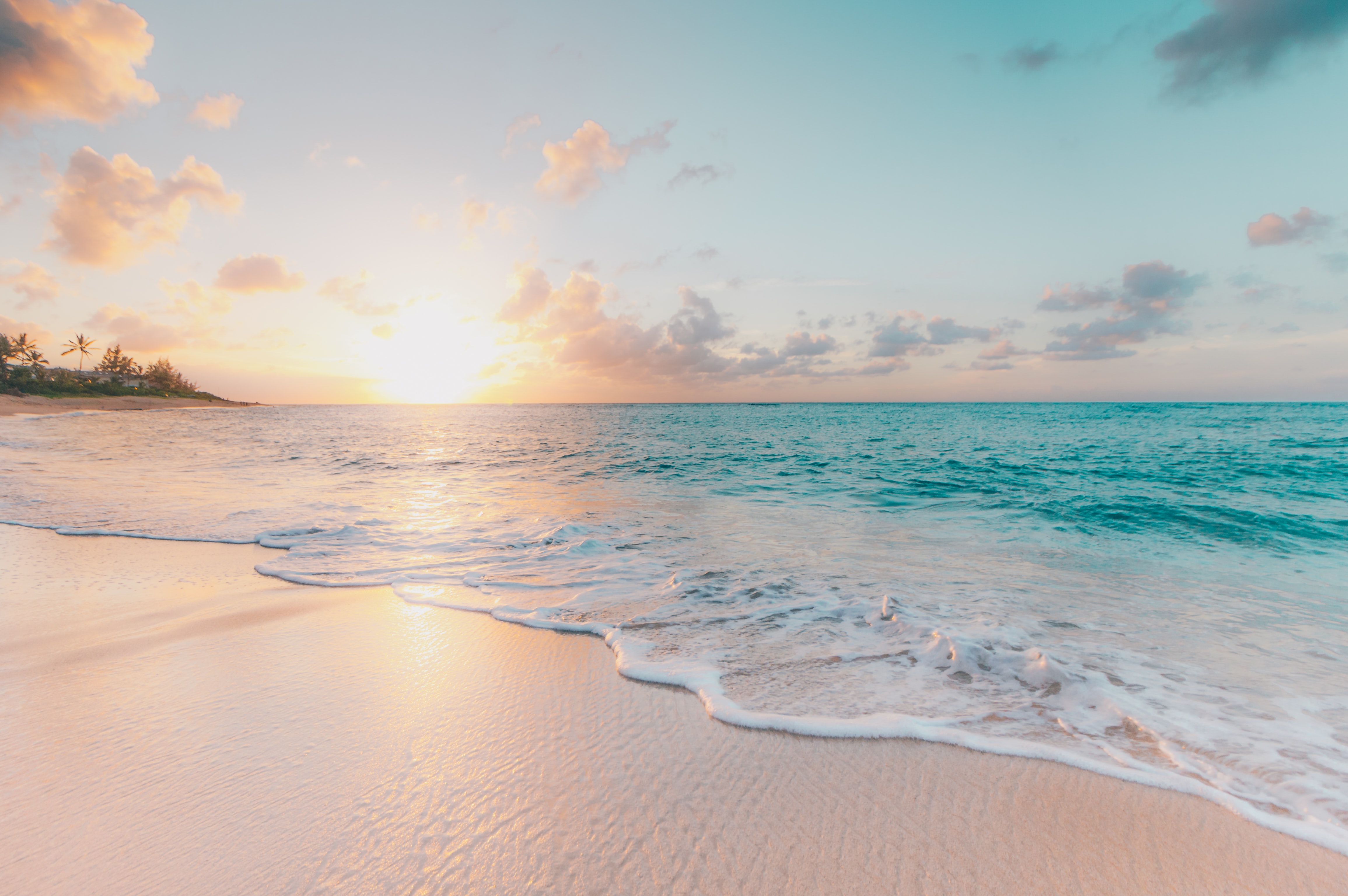 sunset over sea sweeping over beach