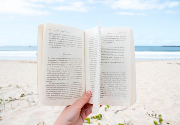 reading a book on the beach