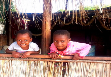 2 children from ponta malongane hanging over fence