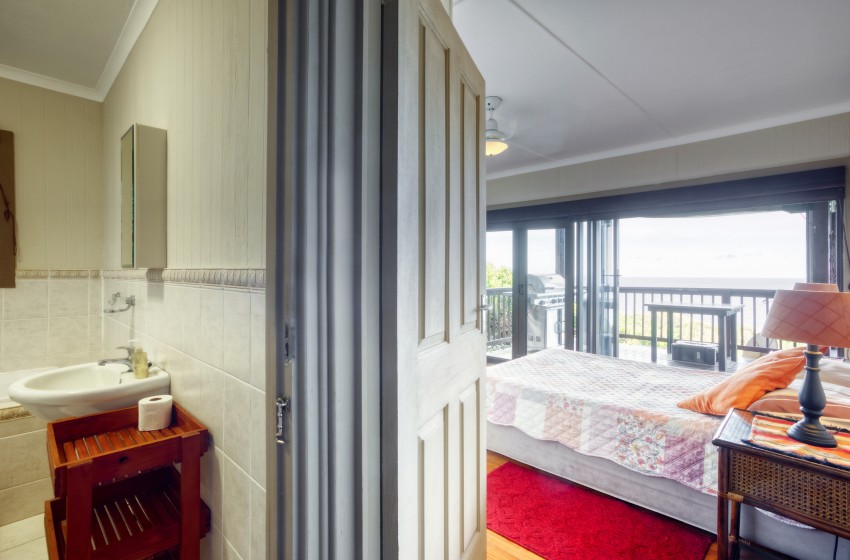 Bedroom with bathroom view at Campismo Ninho 23 in Ponta Malongane