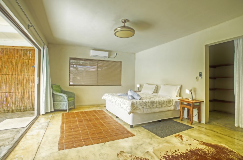 Bedroom 2 with open stacker doors at Baleia Azul 26 in Ponta Mamoli